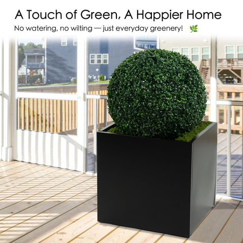 An artificial topiary ball in a black planter, placed on a screened porch. It offers a touch of greenery without the need for watering or maintenance, enhancing the home's aesthetic effortlessly. Artificial Topiary Ball for Effortless Home Greenery. artificial topiary ball, faux green plant sphere, low - maintenance greenery.