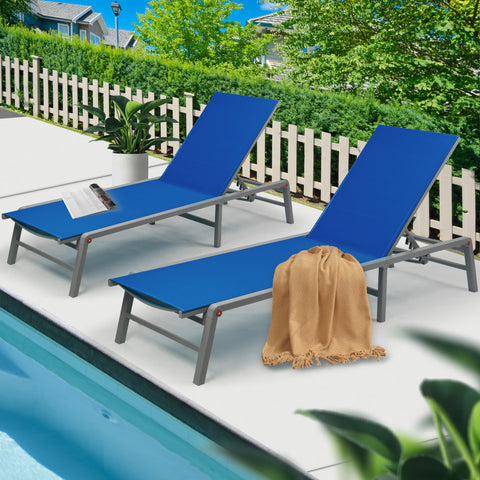 Charming Blue Poolside Lounge Chairs
alt text:Two blue lounge chairs by the pool, accessorized with a magazine and a throw blanket, set against a backdrop of greenery and a white picket fence. Keywords: blue lounge chairs, poolside, outdoor relaxation