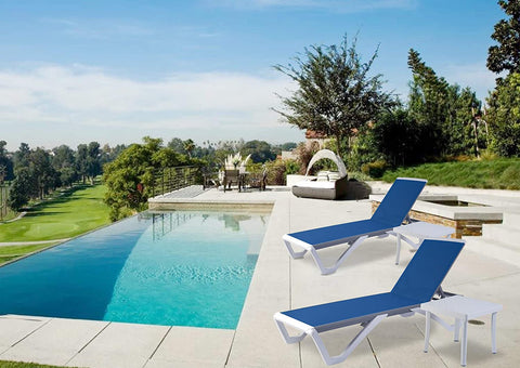 Two modern outdoor blue lounge beds with sleek grey and white frames are placed beside a swimming pool in a luxurious outdoor setting. The lounge beds have adjustable backrests.The background features lush greenery and a scenic view of a golf course. Modern Outdoor Lounge Beds by the Pool. outdoor lounge beds, swimming pool furniture, adjustable backrest, modern design, luxury outdoor setting.