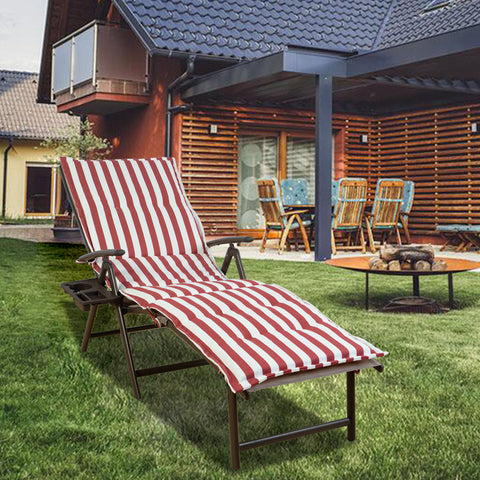 A foldable lounge chair with vibrant red and white striped cushions is placed on a well - maintained lawn in a backyard setting. The chair features a convenient side cup - holder, perfect for relaxing outdoors. The background shows a cozy house with outdoor furniture, enhancing the inviting atmosphere. Red and White Striped Foldable Lounge Chair for Outdoor Relaxation. foldable lounge chair, red and white striped cushions, outdoor relaxation, side cup - holder, backyard furniture.