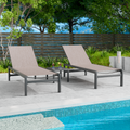 Two beige outdoor lounge chairs with dark frames are positioned beside a swimming pool. The background includes greenery and a wooden fence, creating a relaxing outdoor setting. Beige Outdoor Lounge Chairs: Relax by the Poolside.beige outdoor lounge chairs, poolside furniture, outdoor relaxation, dark - framed lounge chairs