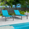 Two blue outdoor lounge chairs with dark frames are positioned beside a swimming pool. The background includes greenery and a wooden fence, creating a relaxing outdoor setting. blue outdoor lounge chairs, poolside furniture, outdoor relaxation, dark-framed lounge chairs.

