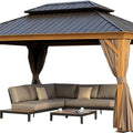 A stylish outdoor aluminum gazebo with a wood - grain finish, featuring a dark metal roof. Inside the gazebo, there is a modern sectional sofa with decorative cushions, accompanied by a coffee table. Beige curtains with darker inner layers hang from the wooden - look posts, creating a cozy and inviting outdoor relaxation space. Cozy Outdoor Aluminum Wood - Grain Gazebo for Relaxation. outdoor aluminum gazebo, wood - grain finish, dark metal roof, sectional sofa, beige curtains