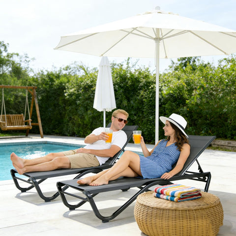 Kozyard outdoor lounge chairs in use: comfortable poolside seating for outdoor leisure, featuring weather-resistant fabric & sturdy frame for enjoyable outdoor gatherings.
