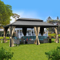 A stylish outdoor gazebo with a dark - hued metal roof stands on a well - manicured lawn. The gazebo is adorned with beige curtains that are tied back, revealing a cozy seating area with wicker furniture and teal cushions. There are also decorative black lanterns placed on the grass, adding to the inviting ambiance. In the background, a charming white -trimmed house and lush greenery can be seen. Cozy Outdoor Gazebo with Wicker Seating on a Green Lawn. outdoor gazebo, wicker furniture, teal cushions, beige.