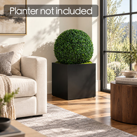 Kozyard faux boxwood topiary ball styled in a square black planter beside a living room window, offering realistic artificial greenery for modern home decor. Dense green foliage creates an elegant indoor plant accent without watering, pruning or maintenance. Ideal for living rooms, entryways, offices, patios and decorative planters. Planter shown in image is not included.
