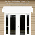 Kozyard modern minimalist door awning with aluminum frame and impact-resistant PVC panels installed above double glass patio doors, providing rain, snow, and UV protection for home entrances.