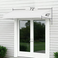 Kozyard 72x40 inch window and door awning with aluminum frame and impact-resistant PVC panels installed above double patio doors for rain, snow, sun and UV protection; modern white outdoor canopy with side wings for home entrances.