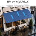 Kozyard 108-inch blue metal awning with integrated front drainage gutter system efficiently channeling rainwater away from cafe shop front windows and outdoor dining patio seating during heavy rainstorms for all-weather protection.