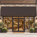 Kozyard 149 inch metal awning installed above a commercial storefront with glass double doors and large display windows, featuring a wide corrugated metal roof panel and wall mounted support brackets. This 12.4 FT outdoor canopy provides extended overhead shade and helps protect business entrances from direct sunlight and rainfall. Ideal for retail storefront awnings, cafe entrances, restaurant door canopies, boutique shops, commercial building facades, and wide exterior doorways.