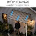 Kozyard heavy-duty metal door canopy showing rain drainage system performance. Front gutter channels rainwater away to the sides efficiently, keeping a man standing at the front door dry and comfortable during heavy rain. Ideal weatherproof overhead door awning for porch.