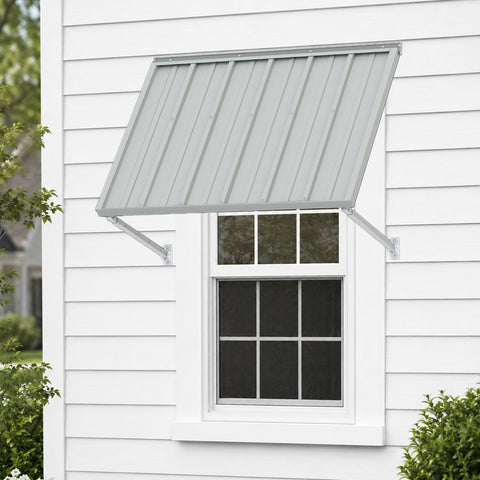 Kozyard 42 inch metal awning installed above a residential window on an exterior siding wall, featuring a corrugated metal roof panel and two adjustable support arms. This compact 3.5 FT wall mounted outdoor window canopy provides overhead shade and helps protect windows from direct sunlight and rainfall. Ideal for residential window awnings, small exterior door canopies, farmhouse windows, backyard entrances, utility room windows, and outdoor home improvement projects requiring compact weather protection.