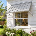 Kozyard 55 inch metal awning installed above a wide residential window on an exterior siding wall, featuring a corrugated metal roof panel and two adjustable support arms. This 4.6 FT wall mounted outdoor window canopy provides extended overhead shade and helps protect windows from direct sunlight and rainfall. Ideal for residential window awnings, kitchen windows, exterior door canopies, farmhouse windows, backyard entrances, porch areas, and home improvement projects requiring durable weather protection.