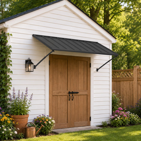 Kozyard 68 inch black metal door awning canopy installed over rustic wooden double doors of a white garden storage shed building. This heavy-duty outdoor patio overhang provides premium weather protection, sun shade shelter, and rain defense for the backyard entryway. The modern corrugated steel design blends seamlessly with traditional vertical siding, making it the perfect addition for residential houses, cabins, workshops, or exterior porch doors requiring a durable rain cover roof.