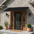 Kozyard 82-inch adjustable metal door awning installed above a modern front entrance, featuring a heavy-duty powder-coated steel frame and black galvanized metal roof. This outdoor door canopy provides reliable rain protection, UV sun shade, snow resistance, and year-round weather protection for residential homes. Designed for front doors, entryways, patios, garages, porches, and commercial storefronts, this durable exterior awning enhances curb appeal while protecting doors and windows from rain, sunlight,