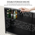 A close - up of a black bar table's double storage shelves, holding various bottles like Rio and Corona Extra. A hand points at the shelves, highlighting the ample space for storing bar essentials and keeping the area organized. Black Bar Table with Double Storage Shelves. Bar table, double storage shelves, bar essentials.
