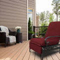 A red-colored outdoor lounge chair with cushioned seating and armrests sits on a wooden deck. Adjacent to it is a wicker chair adorned with a striped throw blanket and a small wicker side table holding a vase of white flowers. The setting includes a house with siding, a railing, and a backdrop of trees.
Red Outdoor Lounge Chair for Relaxing on the Deck.
red outdoor lounge chair, deck furniture, outdoor relaxation, cushioned seating