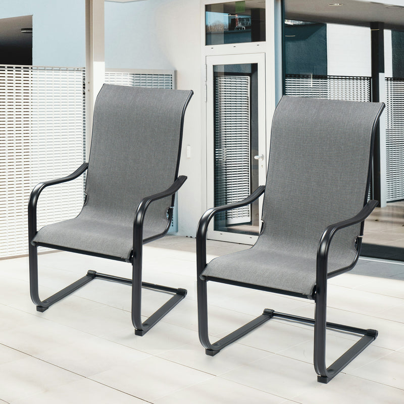 Two gray dining chairs with sleek black metal frames are placed on a light - colored floor in an outdoor - indoor transitional space. The chairs feature curved armrests and high - backed gray fabric seats, providing both style and comfort. Stylish Gray Fabric Dining Chairs with Black Frames. gray dining chairs, black metal frame, fabric - seated chairs, modern dining chairs, indoor - outdoor chairs