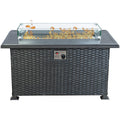 Kozyard rectangular propane fire pit table features a modern gray wicker cabinet, durable slatted aluminum tabletop, clear tempered glass wind guard and decorative fire glass surrounding the gas burner. The front-mounted ignition and adjustable flame control provide convenient operation while the enclosed base creates a clean outdoor furniture appearance. This Kozyard outdoor gas fire table is a stylish propane fire pit centerpiece for patios, decks, backyards, gardens and outdoor conversation seating areas