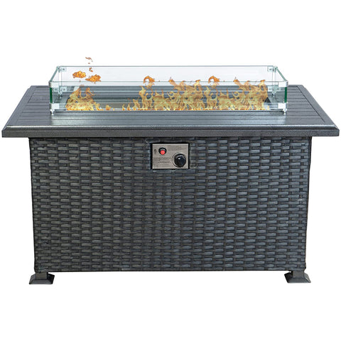 Kozyard rectangular propane fire pit table features a modern gray wicker cabinet, durable slatted aluminum tabletop, clear tempered glass wind guard and decorative fire glass surrounding the gas burner. The front-mounted ignition and adjustable flame control provide convenient operation while the enclosed base creates a clean outdoor furniture appearance. This Kozyard outdoor gas fire table is a stylish propane fire pit centerpiece for patios, decks, backyards, gardens and outdoor conversation seating areas