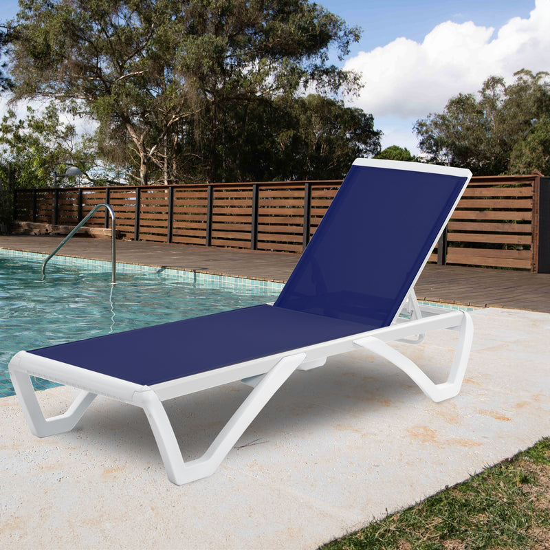 A stylish outdoor lounge bed with a deep blue fabric surface and a sleek white frame is positioned beside a swimming pool. The setting includes a wooden fence and trees in the background, suggesting a relaxing backyard environment.Blue Outdoor Lounge Bed by the Pool. outdoor lounge bed, blue fabric, white frame, swimming pool, backyard relaxation.