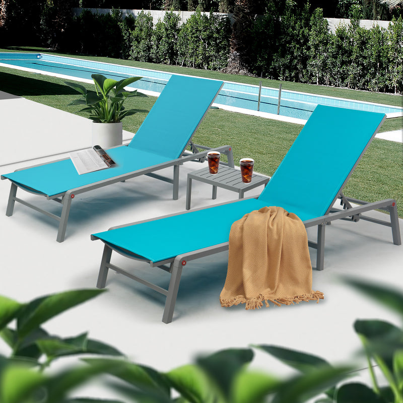 Chic Blue Outdoor Lounge Chair Set by Pool
alt text：A stylish set of blue outdoor lounge chairs with a small side table, placed by a pool and accessorized with a magazine, drinks, and a throw blanket. Keywords: blue outdoor lounge chairs, poolside, patio set
