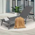 Stylish Gray Outdoor Lounge Chair
alt text：A gray outdoor lounge chair adorned with a beige throw blanket and a magazine, placed on a patterned rug next to a potted plant, ideal for patio relaxation. Keywords: gray lounge chair, outdoor relaxation, patio decor