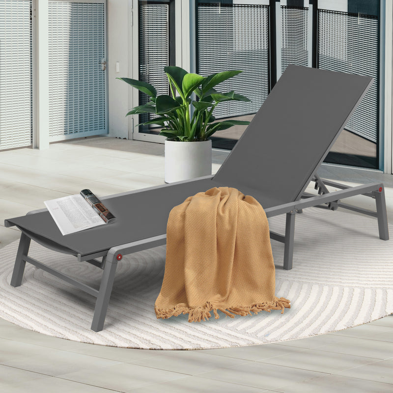 Stylish Gray Outdoor Lounge Chair
alt text：A gray outdoor lounge chair adorned with a beige throw blanket and a magazine, placed on a patterned rug next to a potted plant, ideal for patio relaxation. Keywords: gray lounge chair, outdoor relaxation, patio decor
