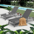 Elegant Gray Poolside Lounge Chair Set
alt text：A set of gray lounge chairs by the pool, accessorized with a magazine, drinks, and a beige throw blanket, set against a backdrop of greenery and a pool. Keywords: gray lounge chairs, poolside, outdoor relaxation
