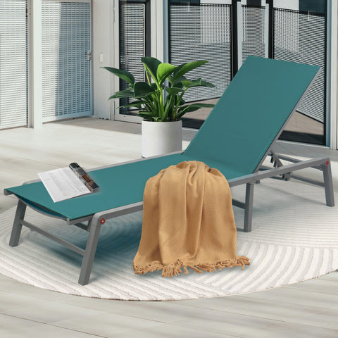 Cozy Teal Outdoor Lounge Chair
alt text：A teal outdoor lounge chair adorned with a beige throw blanket and a magazine, placed on a patterned rug next to a potted plant, perfect for patio relaxation. Keywords: teal lounge chair, outdoor relaxation, patio decor