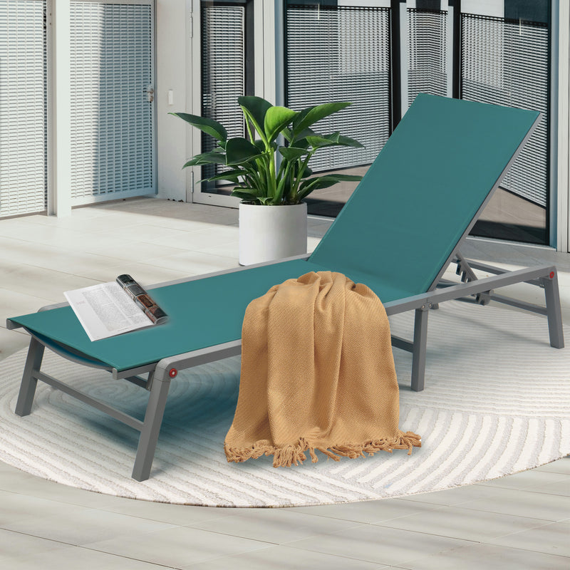 Cozy Teal Outdoor Lounge Chair
alt text：A teal outdoor lounge chair adorned with a beige throw blanket and a magazine, placed on a patterned rug next to a potted plant, perfect for patio relaxation. Keywords: teal lounge chair, outdoor relaxation, patio decor