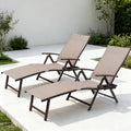 Kozyard set of 2 outdoor chaise lounge chairs featuring adjustable reclining backrests, breathable beige sling fabric, sturdy metal frames and convenient built-in cup holder trays. These folding patio lounge chairs provide comfortable seating for poolside, deck, porch, backyard, garden and sunbathing areas, combining durable outdoor construction with relaxing zero gravity style comfort.