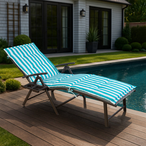 A foldable lounge chair with striking blue and white striped cushions is placed beside a pool, overlooking the sea. The chair comes with a convenient side cup - holder, perfect for relaxing by the water.Foldable Lounge Chair with Blue - White Striped Cushions by the Poolside. foldable lounge chair, blue and white striped cushions, poolside chair, side cup - holder, seaside relaxation.