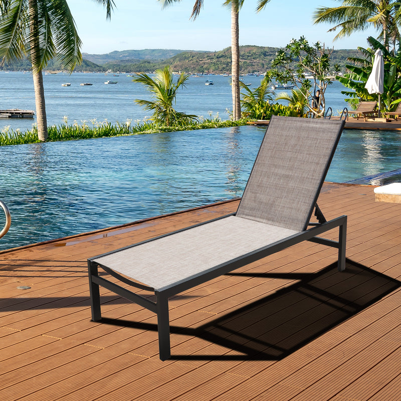 A beige - toned outdoor lounge chair with a black metal frame is positioned on a wooden deck by a pool, overlooking a scenic waterfront with palm trees, boats, and distant hills.Beige Outdoor Lounge Chair: Relax by the Pool with a View. beige outdoor lounge chair, poolside lounge chair, waterfront view, wooden deck furniture, black - framed lounge chair.
