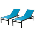 Two outdoor lounge chairs with vibrant blue fabric resting on black metal frames. They are designed for relaxation, suitable for poolside or patio settings. Blue Outdoor Lounge Chairs: Relax in Style. blue outdoor lounge chairs, black - framed lounge chairs, outdoor relaxation furniture, patio loungers.