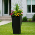 Kozyard tall outdoor planter creates an elegant garden display for flowers, ornamental grasses, shrubs and decorative plants. This modern tapered metal planter is ideal for front porch, patio, deck, entryway, backyard, garden and landscaping use, offering a spacious large plant container with a sleek contemporary profile for seasonal flowers, greenery and eye-catching outdoor arrangements.