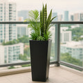 Kozyard tall planter adds a modern vertical accent to balconies, patios, porches and indoor outdoor living spaces. This large tapered metal plant container provides ample room for snake plants, palms, succulents, flowers and decorative greenery, making it a versatile floor planter for apartments, entryways, offices, decks, rooftop terraces and contemporary residential or commercial landscaping.