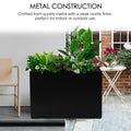 A black metal rectangular planter box with a sleek matte finish, filled with lush green plants. Crafted from quality metal, it's suitable for both indoor and outdoor settings, enhancing any space with greenery. Black Metal Rectangular Planter Box - Quality Metal Construction. Metal planter box, rectangular, steel, indoor - outdoor use, matte finish.