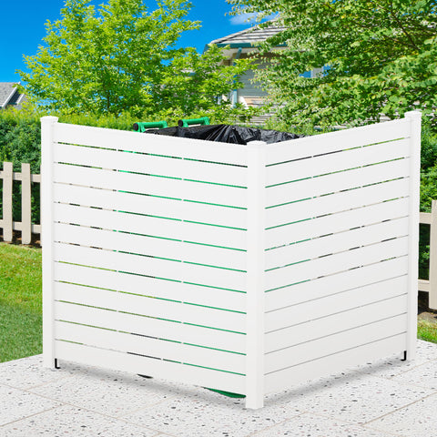 A white outdoor privacy fence with horizontal slats, used to conceal trash cans. The fence is set against a backdrop of greenery and a clear blue sky, placed on a pebble - like hard surface. White Outdoor Fence for Trash Can Concealment. outdoor fence, white fence, privacy fence, trash can cover, yard decor