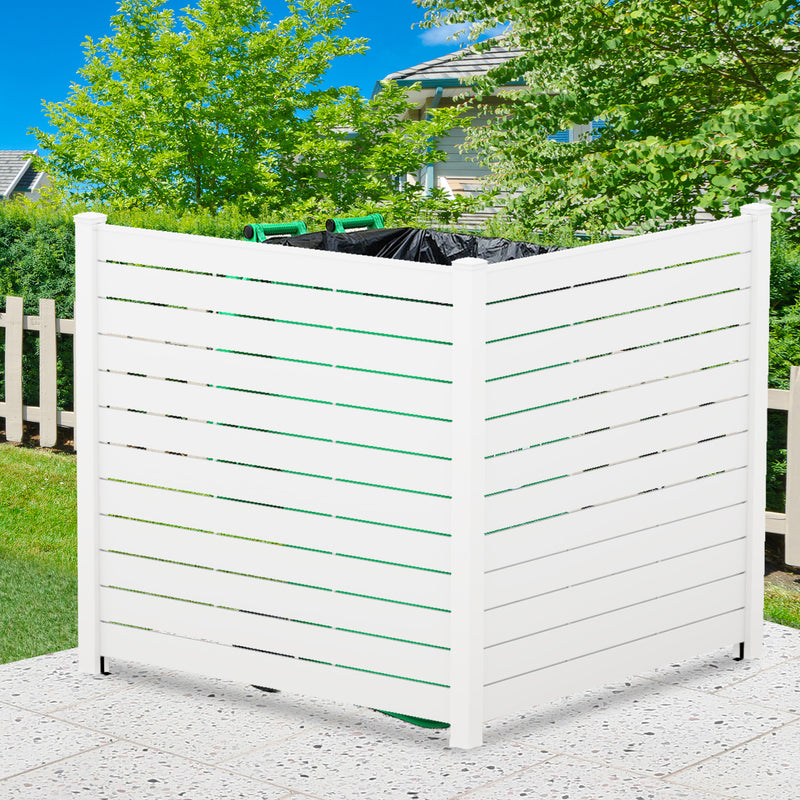 A white outdoor privacy fence with horizontal slats, used to conceal trash cans. The fence is set against a backdrop of greenery and a clear blue sky, placed on a pebble - like hard surface. White Outdoor Fence for Trash Can Concealment. outdoor fence, white fence, privacy fence, trash can cover, yard decor