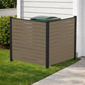 Kozyard outdoor privacy screen fence enclosure designed for hiding trash cans and backyard air conditioner units. This durable taupe WPC wood plastic composite privacy fence panels with black aluminum frame blends seamlessly with home siding, enhancing curb appeal while providing a heavy-duty freestanding screening solution for gardens, lawns, and driveways. Ideal for concealing unsightly outdoor utilities and waste bins stylishly.