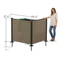 Kozyard outdoor privacy screen dimensions guide with a woman model for size reference. Technical drawing highlights product measurements including 47-5/8 inches height, 50-5/8 inches width, 2-3/8 inches post width, and 11-inch ground stake anchors. Perfect size enclosure for standard residential wheelie trash cans, waste bins, air conditioning compressors, and heat pump units.