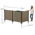 Kozyard large 3-panel outdoor privacy screen dimensions guide with a woman model for scale reference. Technical illustration displays product measurements including 47-5/8" height, 99" extended long side width, 50-5/8" short side width, 2-3/8" post width, and 11" ground stakes. Extra-large enclosure capacity ideal for hiding dual trash bins, waste dumpsters, or multiple heat pumps.