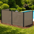 Kozyard 3-panel outdoor privacy screen fence enclosure standing poolside to hide backyard utilities. This premium taupe WPC wood plastic composite privacy fence panel features a heavy-duty black aluminum frame, beautifully concealing pool filtration pumps or dual air conditioner condenser units. Freestanding decorative yard screening structure perfectly blends with landscaping mulch and green lawns while enhancing patio aesthetics.