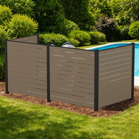 Kozyard 3-panel outdoor privacy screen fence enclosure standing poolside to hide backyard utilities. This premium taupe WPC wood plastic composite privacy fence panel features a heavy-duty black aluminum frame, beautifully concealing pool filtration pumps or dual air conditioner condenser units. Freestanding decorative yard screening structure perfectly blends with landscaping mulch and green lawns while enhancing patio aesthetics.