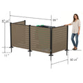 Kozyard large 3-panel outdoor privacy screen dimensions guide with a woman model for scale reference. Technical illustration displays product measurements including 47-5/8" height, 99" extended long side width, 50-5/8" short side width, 2-3/8" post width, and 11" ground stakes. Extra-large enclosure capacity ideal for hiding dual trash bins, waste dumpsters, or multiple outdoor HVAC heat pumps.