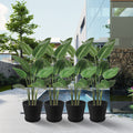 In an elegant outdoor setting featuring a modern building, a swimming pool, and lush greenery, four black plastic plant pots with attached saucers hold vibrant tropical plants. The pots add a touch of sophistication and greenery to the upscale outdoor space.Black Plastic Plant Pots: Upgrade Your Outdoor Oasis. black plastic plant pots, outdoor planters, plant pots with saucers, tropical plants in pots, upscale outdoor decor.