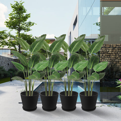 In an elegant outdoor setting featuring a modern building, a swimming pool, and lush greenery, four black plastic plant pots with attached saucers hold vibrant tropical plants. The pots add a touch of sophistication and greenery to the upscale outdoor space.Black Plastic Plant Pots: Upgrade Your Outdoor Oasis. black plastic plant pots, outdoor planters, plant pots with saucers, tropical plants in pots, upscale outdoor decor.