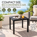 Kozyard compact black outdoor side table for patio, balcony and poolside use, featuring a square slatted metal tabletop and modern space-saving design. Ideal as a patio end table beside outdoor chairs for holding drinks, books, sunglasses, plants and décor. Durable outdoor accent table adds convenient surface space to decks, porches, gardens and small balconies.