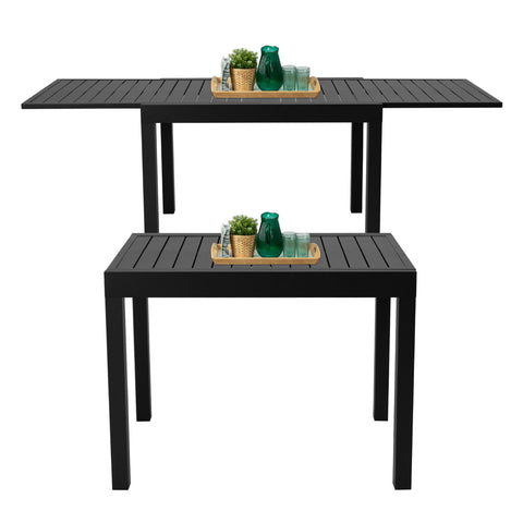 Kozyard aluminum expandable outdoor table shown in compact and extended form, featuring slatted tabletop, smooth pull-out extension panels and decor items for patio use.